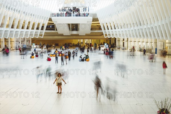 New York City, USA, June 24, 2018: Interior view of World Trade Center Transportation Hub or Oculus designed by Santiago Calatrava architect. Long exposure, motion blur, North America