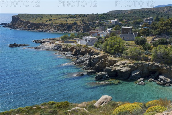 Coastal landscape with rocky shores, clear blue water and picturesque houses under a clear sky, Kyparissos, Mani, Laconia, Laconia, Peloponnese, Greece, Europe