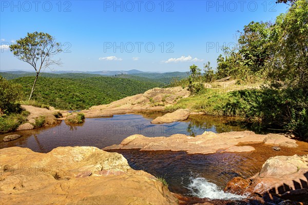 River with calm, transparent waters among the rocks, mountains and vegetation of the Muaimii environmental reserve in Minas Gerais
