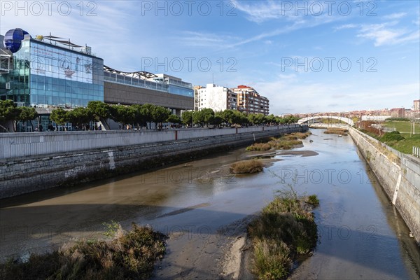 Madrid, Spain, December 9, 2019: Cityscape of Manzanares River in Madrid Rio area, Europe