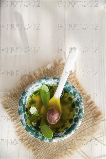 Presentation of small container of extra virgin olive oil