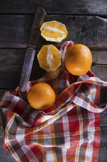 Lots of freshly picked oranges on dark table