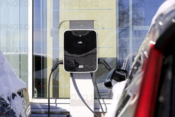 Two electric cars plugged in DEFA charger with two outlets to recharge battery. Salo, Finland. March 12, 2023