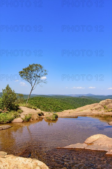River with calm waters among the rocks, mountains and vegetation of the Muaimii environmental reserve in Minas Gerais