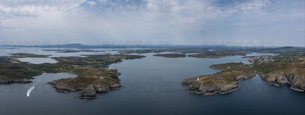 A panorama view of the entrance to the Baltimore Harbor in West Cork with teh Sherkin Island Lighthouse and the Baltimore Beacon
