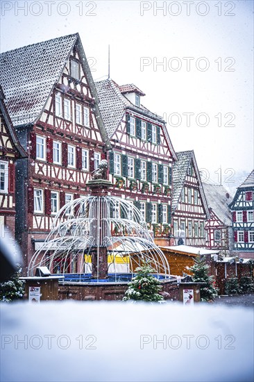 Half-timbered house backdrop on a snow-covered Christmas market with winter decorations, Black Forest, Calw, Germany, Europe