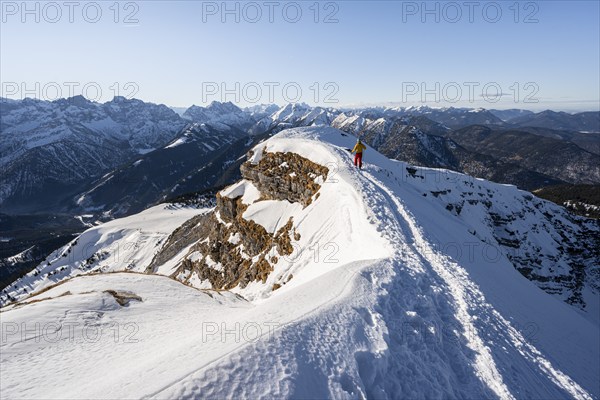 Ski tourers at the summit of Schafreuter, view of snow-covered mountain panorama, Karwendel, Tyrol, Austria, Europe