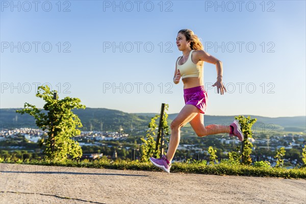 Young woman in Fitness training, vineyard at Grossheppach, Remstal valley, Baden Württemberg, Germany, Europe