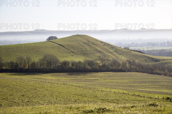 Picked Hill chalk outlier landscape misty valley floor, Vale of Pewsey, from Woodborough Hill, Wilcot, Wiltshire, England, UK
