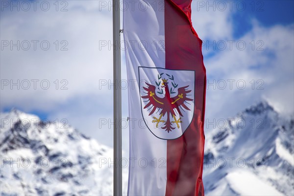 Flag of Tyrol with mountains in the background