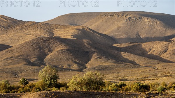 Mountain and hilly landscape in the evening light, sandstone hills, Fint, Morocco, Africa