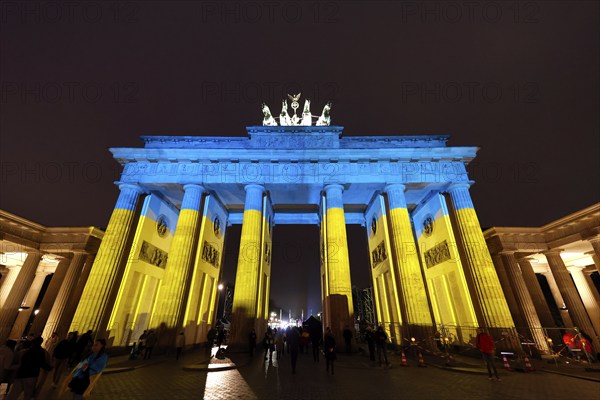 On the anniversary of the Russian war of aggression against Ukraine, the Brandenburg Gate is illuminated in the national colours of Ukraine, Berlin, 24.02.2023