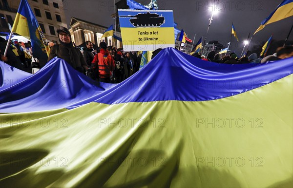 People demonstrate with a huge Ukrainian flag at the Brandenburg Gate on the anniversary of the Russian war of aggression against Ukraine, Berlin, 24 February 2023