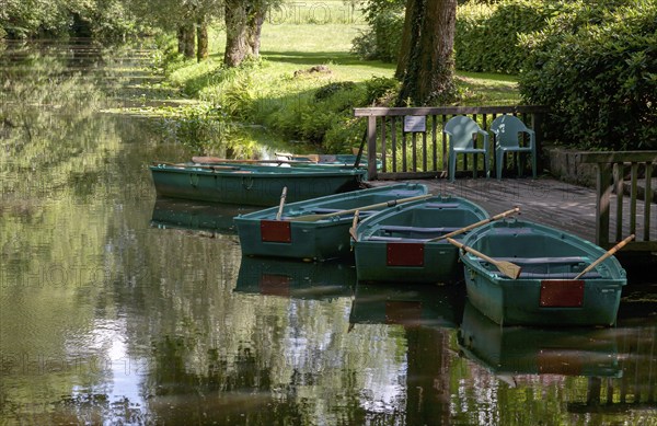 Green boats on the wooden jetty, Alstätter Aa near the Haarmühle, Ahaus-Alstätte, Münsterland, North Rhine-Westphalia, Germany, Europe