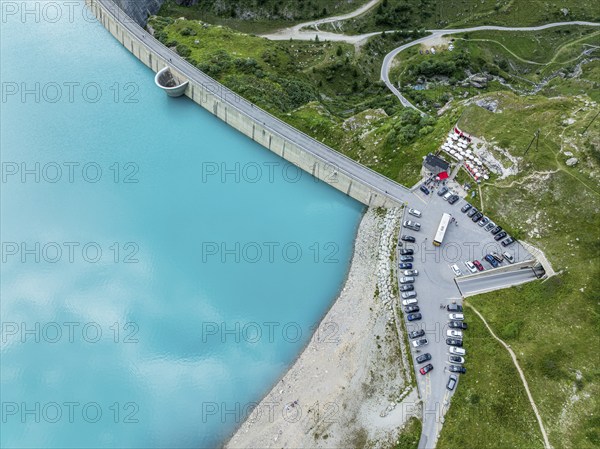 Dam of the Moiry lake, Lac de Moiry, turquoise glacial water, parking lot and restaurant at the dam, aerial view, Valais, Switzerland, Europe