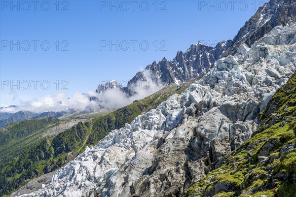 Glacier ice of the Glacier des Bossons, behind pointed mountain peaks, Chamonix, Haute-Savoie, France, Europe