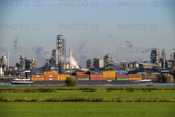 Cargo ship on the Rhine near Emmerich, Kao Chemicals backdrop, specialising in surfactants, KLK, Left Rhine pastures, Lower Rhine, North Rhine-Westphalia, Germany, Europe