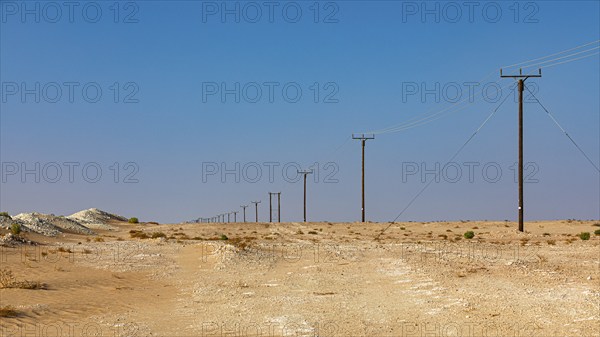Power line runs through the Rub al Khali desert, Dhofar province, Arabian Peninsula, Sultanate of Oman