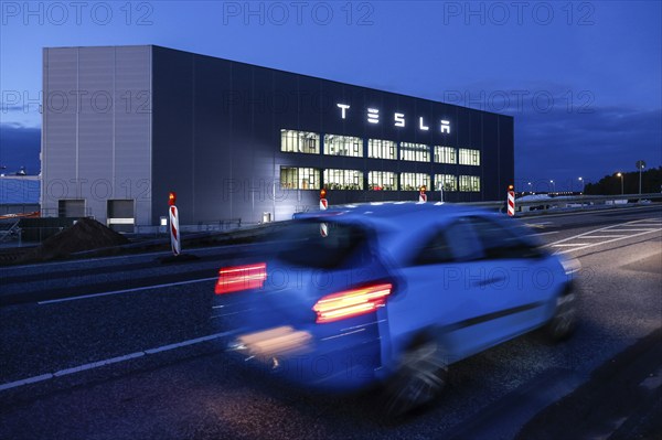 A car drives past the battery factory of the Tesla plant, Grünheide, 13.01.2023