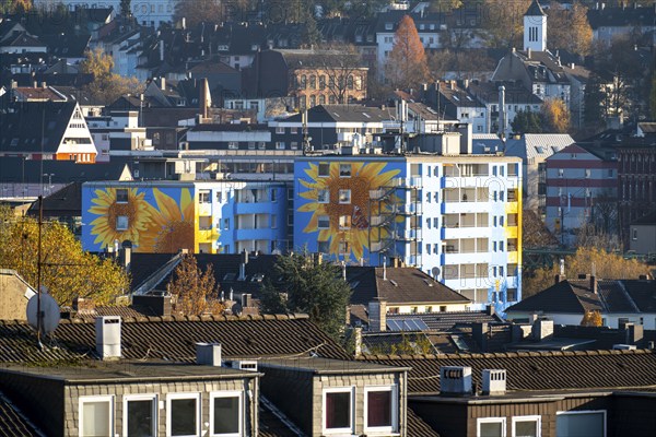 Residential building in Wuppertal-Oberbarmen, Berliner Straße, the façade was painted with large sunflowers after a renovation, Wuppertal, North Rhine-Westphalia, Germany, Europe