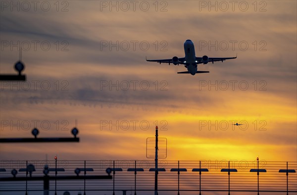 Runway lighting, approach aids, at Düsseldorf International Airport, sunset, aircraft taking off and approaching the southern main runway, 05R/23L, North Rhine-Westphalia, Germany, Europe