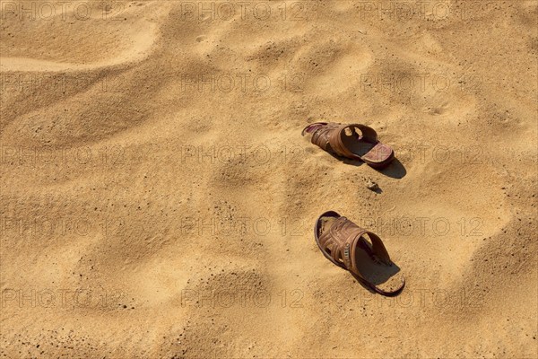 Two sandals on sandy ground in a desert, Matruh, Great Sand Sea, Libyan Desert, Sahara, Egypt, North Africa, Africa