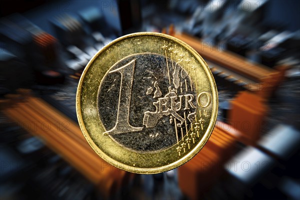 Symbolic image of the digital euro: one-euro coin against a virtual background