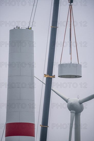 Construction of the tower of a wind power plant in a wind farm near Issum, 9 older wind turbines from the manufacturer Enercon (model series E-58) at the rear right, which have been in operation for over two decades, will be replaced by a total of four Enercon E-160 turbines, under construction, with a total output of 22 megawatts, Lower Rhine, North Rhine-Westphalia, Germany, Europe