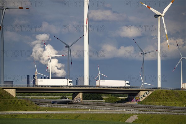 RWE Windpark Jüchen A44n, Garzweiler wind farm, at the Garzweiler opencast lignite mine, on the A44 motorway, Jackerath motorway junction, including Nordex N149 wind turbines, located on recultivated areas of the opencast lignite mine, in the background the RWE Power Neurath coal-fired power station, North Rhine-Westphalia, Germany, Europe