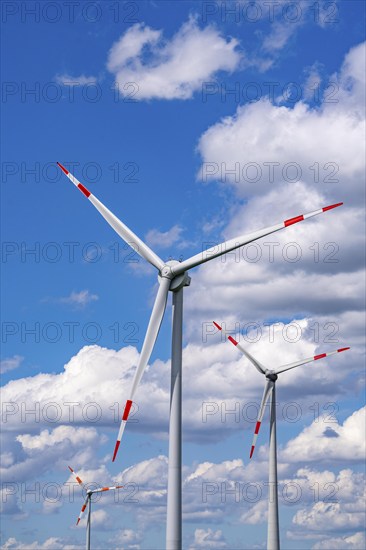 Wind turbine, wind energy plant from the manufacturer Enercon, blue sky with many white clouds, near Schermbeck, North Rhine-Westphalia, Germany, Europe