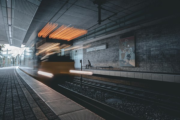 An underground railway moves through a modern, urban station with traces of light, Weinsteige, Stuttgart, Germany, Europe