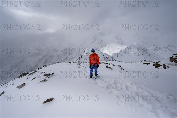 Ski tourers on the summit of the Köllkuppe or Cima Marmota, snow-covered mountain landscape, Ortler Alps, Vinschgau Valley, Italy, Europe