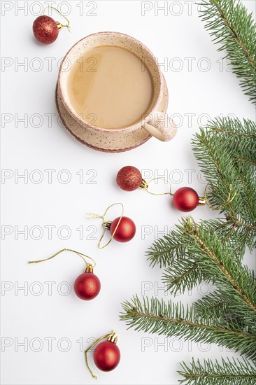 Christmas or New Year composition. Decorations, red balls, fir and spruce branches, cup of coffee, on a white paper background. Top view, copy space, flat lay