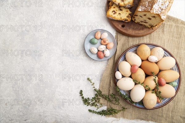 Homemade easter pie with raisins and eggs on plate on a gray concrete background and linen textile. top view, flat lay, copy space
