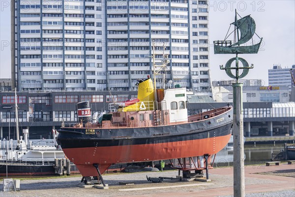 Old harbour, harbour basin, harbour district, museum ships, harbour tugboat Stier, part of the Harbour Worlds, high-rise buildings at the Columbus Center, in Bremerhaven, Bremen, Germany, Europe