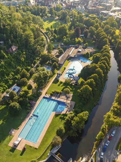 Aerial view of an extensive swimming pool complex with several pools, surrounded by trees and neighbouring urban areas, Nagold, Black Forest, Germany, Europe