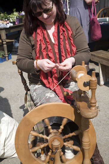 Woman demonstrating traditional spinning at a country craft event, Shottisham, Suffolk, England, United Kingdom, Europe