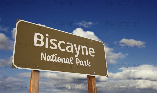 Biscayne national park (florida) road sign against blue sky and clouds