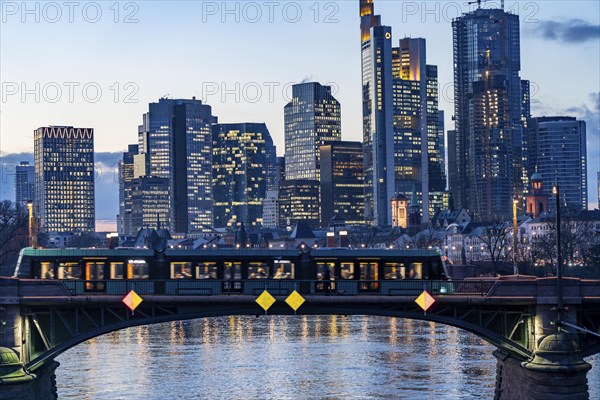 Skyline of the city centre of Frankfurt am Main, river Main, dusk, Ignatz-Bubis-Brücke, tram, Hesse, Germany, Europe