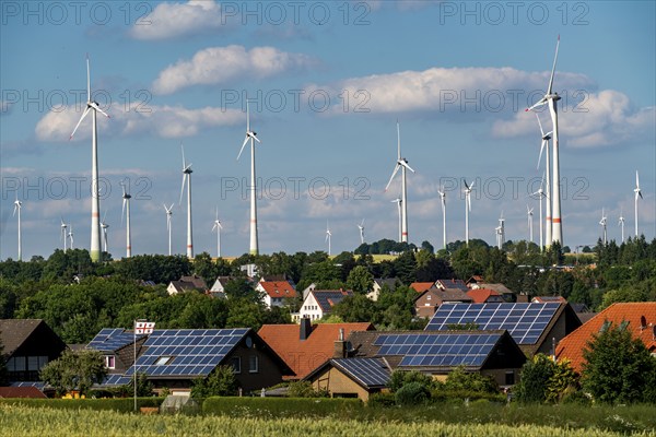 Wind farm near the East Westphalian town of Energiestadt Lichtenau, many residential buildings with photovoltaic systems on the roofs, over 80 wind turbines on this hill, in total there are more than 200 wind turbines around the town, producing 9 times more electricity than the town itself consumes, the rest is fed into the grid, North Rhine-Westphalia, Germany, Europe