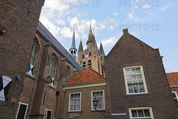 Historic city centre of Delft, Museum Het Prinsenhof in the former Sint Agatha monastery is dominated by the tower of the Gothic Old Church, Oude Kerk, Delft, Zuid-Holland, Netherlands