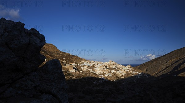 A village in the early morning light, surrounded by dark hills and rocks, illuminated by moon or stars, Colourful mountain village, Morning light, Olymbos, Karpathos, Dodecanese, Greek Islands, Greece, Europe