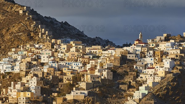 A traditional mountain village glows in the golden sunlight and conveys a Mediterranean atmosphere, Colourful mountain village, Morning light, Olymbos, Karpathos, Dodecanese, Greek Islands, Greece, Europe