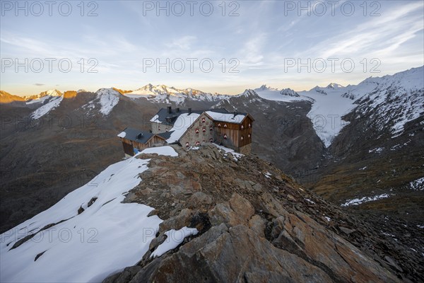 Snow-covered mountain landscape, mountain hut Ramolhaus in autumn with snow, at sunset, view of Gurgler Ferner with summit Hochwilde and Falschungsspitze, Ötztal Alps, Tyrol, Austria, Europe