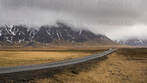 Highway countryside straight empty road leading to the snowy mountains at snaefellsnes peninsula in Iceland