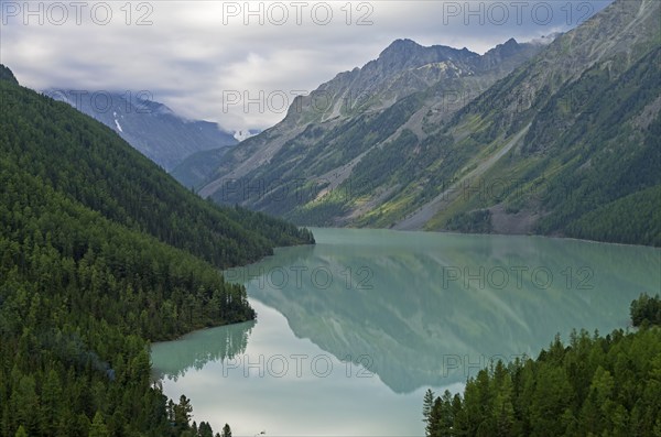 Reflection of mountains in the lake. Kucherla lake. Altai Mountains, Russia. Overcast summer morning