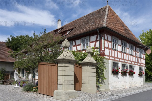 Court gate with vase attachments from 1774, on the right former Ebracher Schultheissenhof from 1778, Hüttenheim 58, Hüttenheim, . Lower Franconia, Bavaria, Germany, Europe