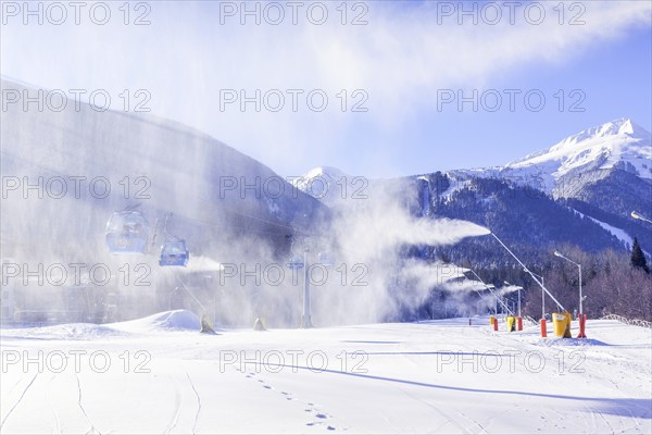 Bansko, Bulgaria, January 28, 2021: Bulgarian winter ski resort panorama with gondola lift cabins, Pirin mountain peaks view and slope, Europe