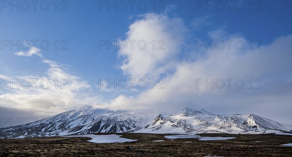 Typical Icelandic landscape with mountains and meadow land covered in snow at snaefellsnes peninsula in Iceland
