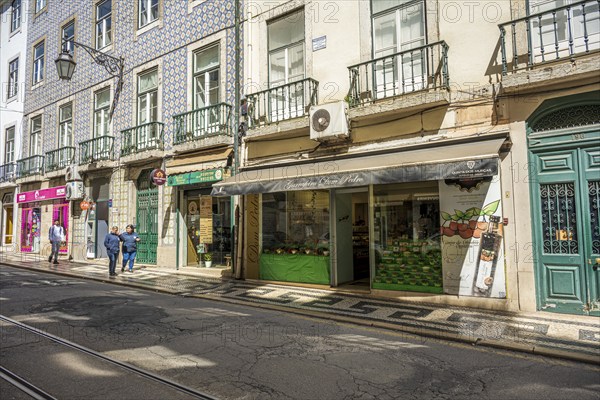 Grocery shop in Lisbon, Lively shopping street with historic buildings and shops in daylight, Lisbon, Portugal, Europe